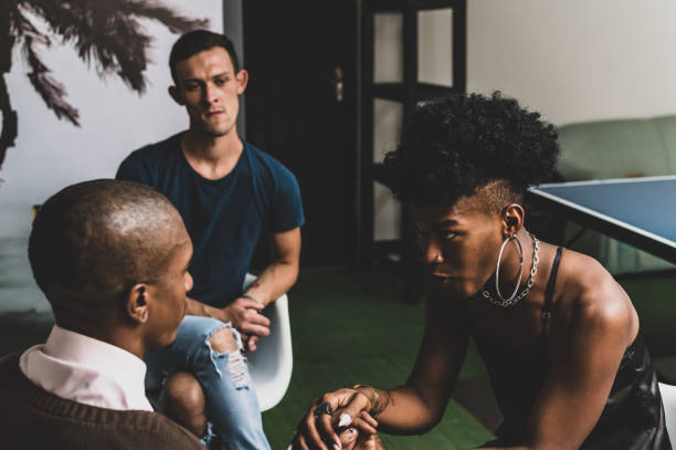 Two transgender women, a gay man and a non-binary person in a therapeutic support group.